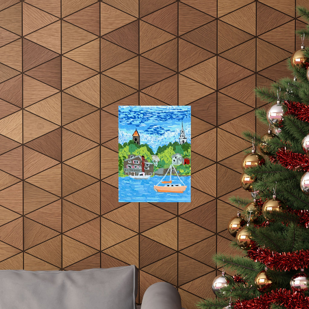 “Coastal harbor sailboat poster on a wood-paneled wall beside a decorated Christmas tree.”