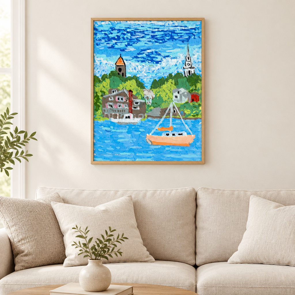“Harbor sailboat artwork in a light wood frame above a cream sofa.”
